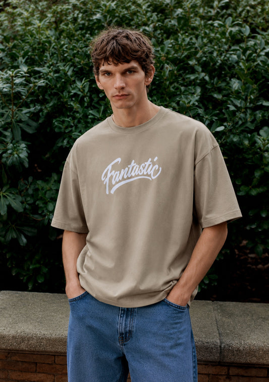 Montx men's beige loose fit street style T-shirt with vibrant print, casual and comfortable for everyday wear.
