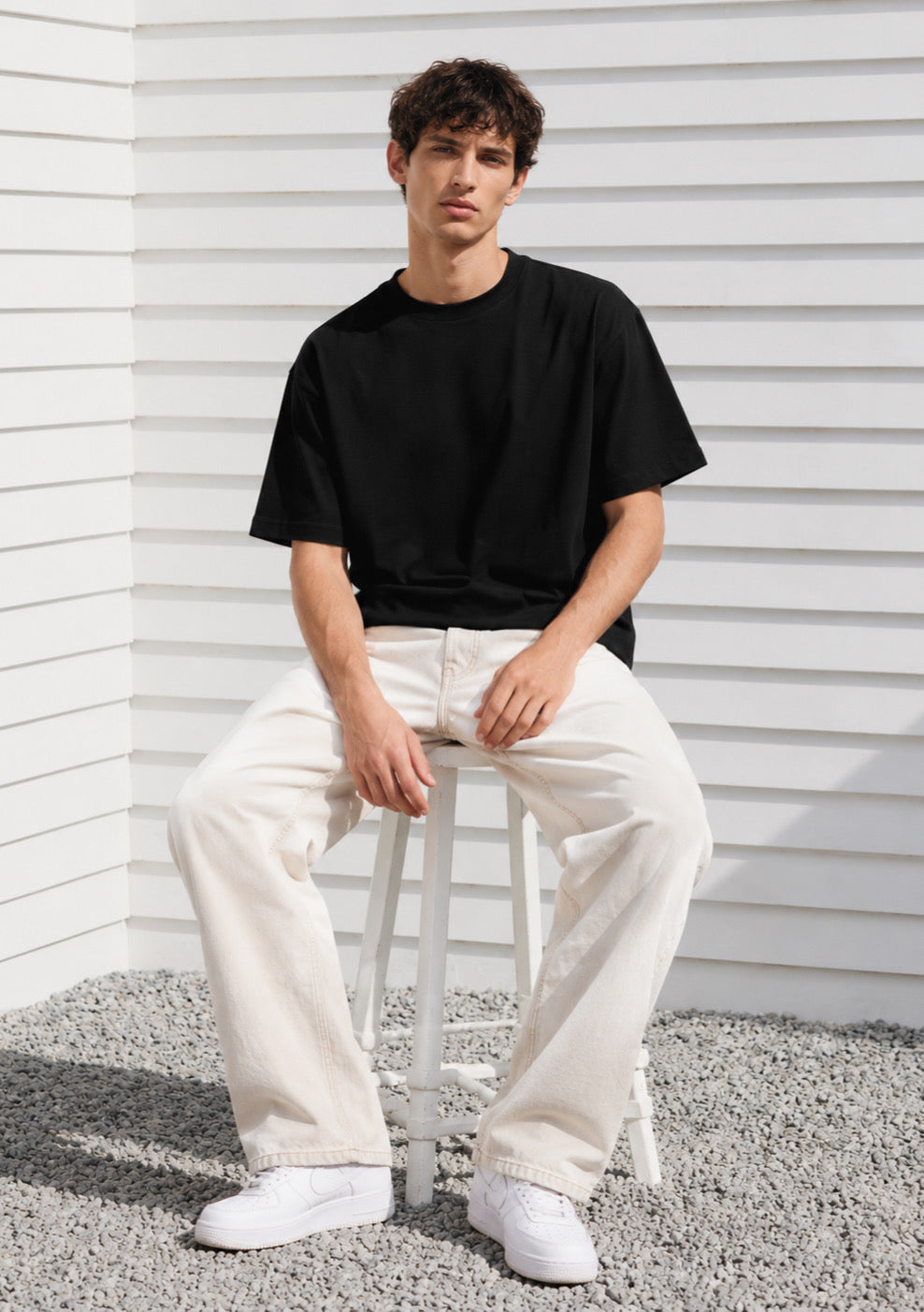 Black Montx Essential boxy fit T-shirt for men, showcasing a relaxed, stylish silhouette and soft cotton fabric.