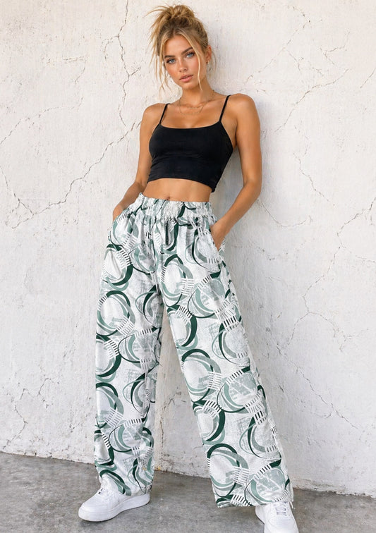 Montx Women’s sage green abstract print wide leg joggers with relaxed fit, shown on a model. Comfortable casual loungewear.