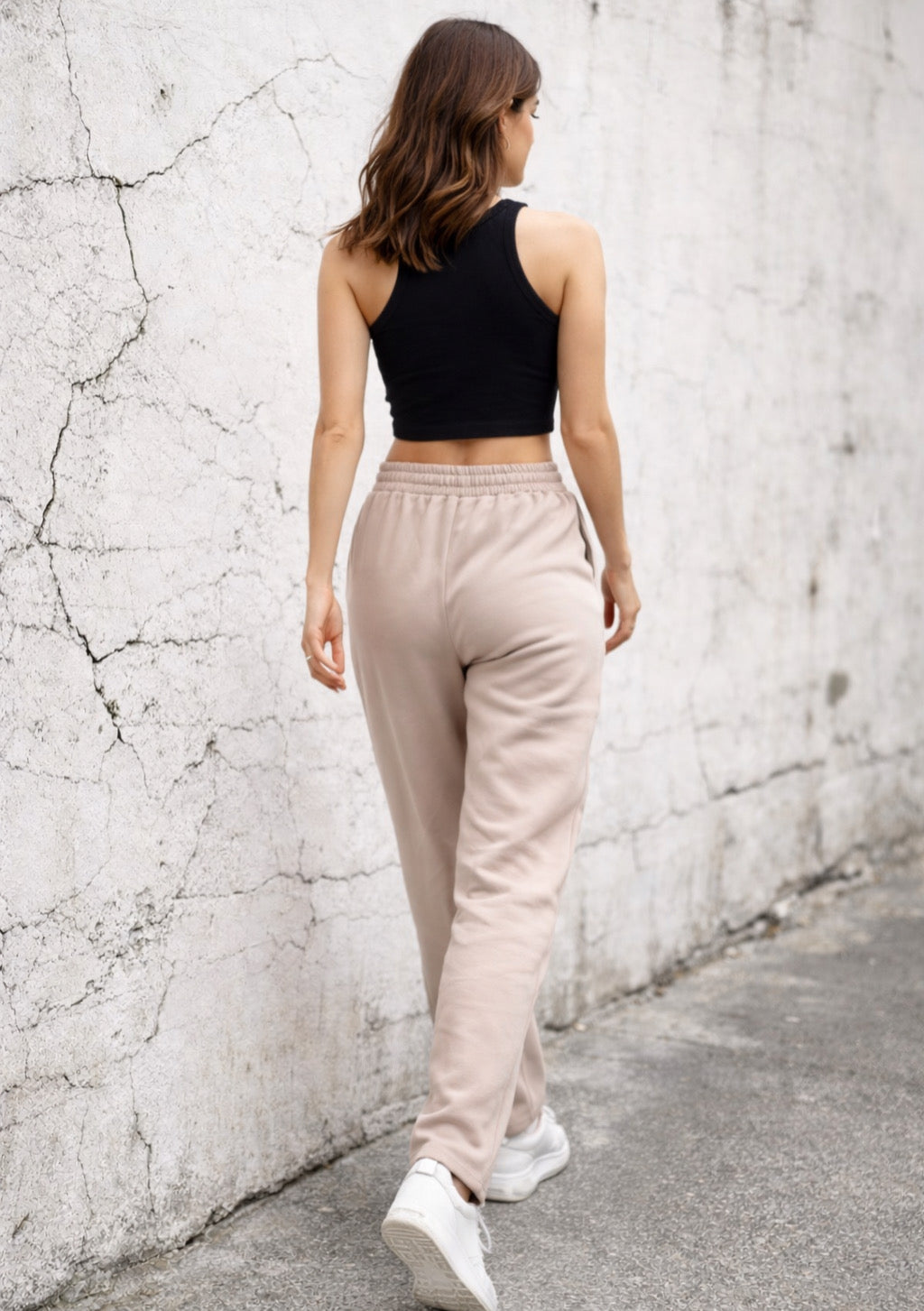 Light brown women's wide-leg joggers from Montx, soft lounge fit with relaxed, comfortable style, shown hanging on a clothing rack.