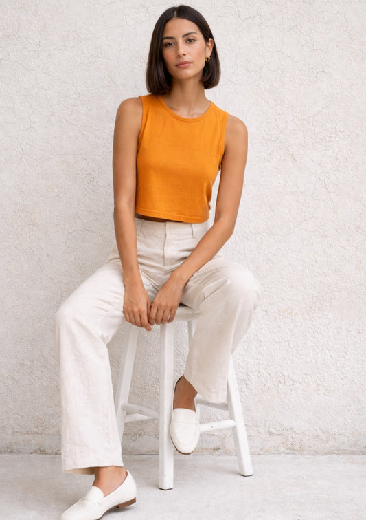 Montx women's orange sleeveless crop top with slim fit, shown on a model, perfect for casual summer outfits.