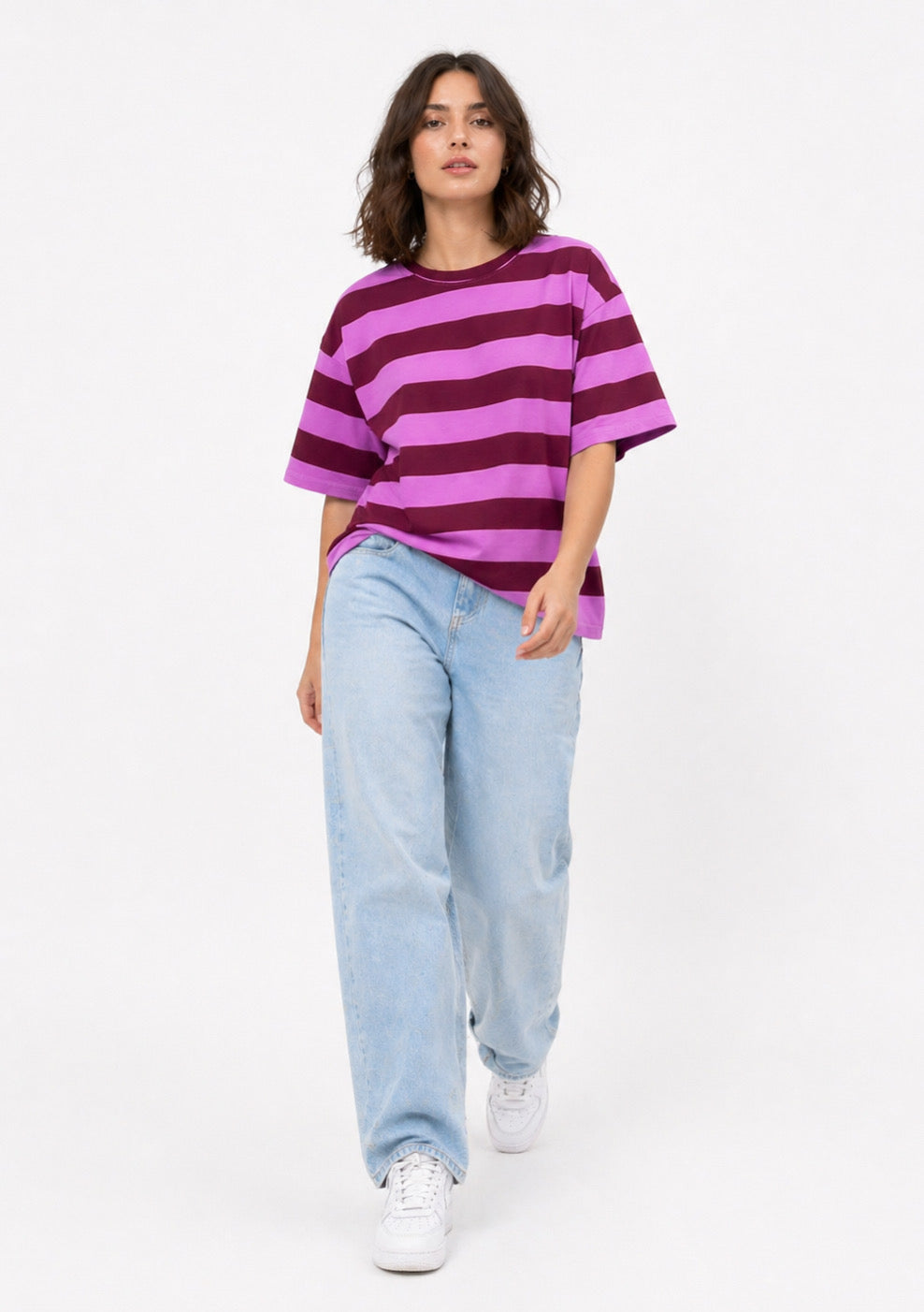 Montx women's oversized purple striped T-shirt laid flat, showcasing relaxed fit and bold striped pattern.