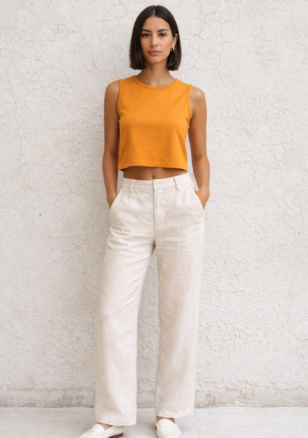 Orange sleeveless crop top for women by Montx The Clothing Brand, slim fit style, shown on a plain background.