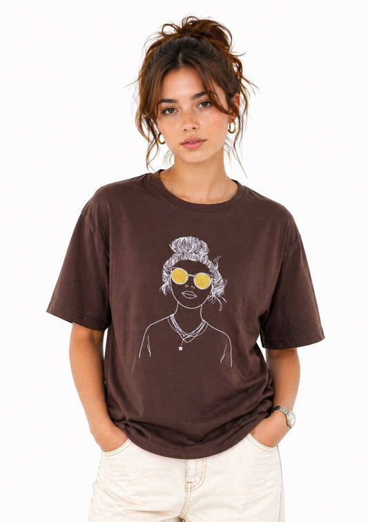 Montx Women's brown graphic oversized T-shirt with bold print, soft fabric, and relaxed fit, perfect for casual wear.
