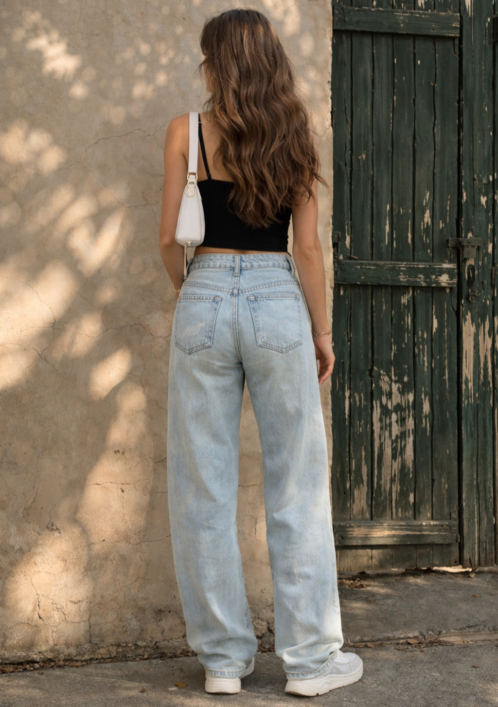 Montx women's dusty light blue straight fit denim jeans displayed on a model, showcasing classic style and relaxed fit.