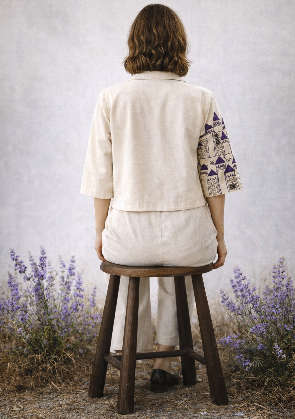 Montx Women's linen embroidered co-ord set in ivory and purple, featuring a stylish top and matching wide-leg pants.