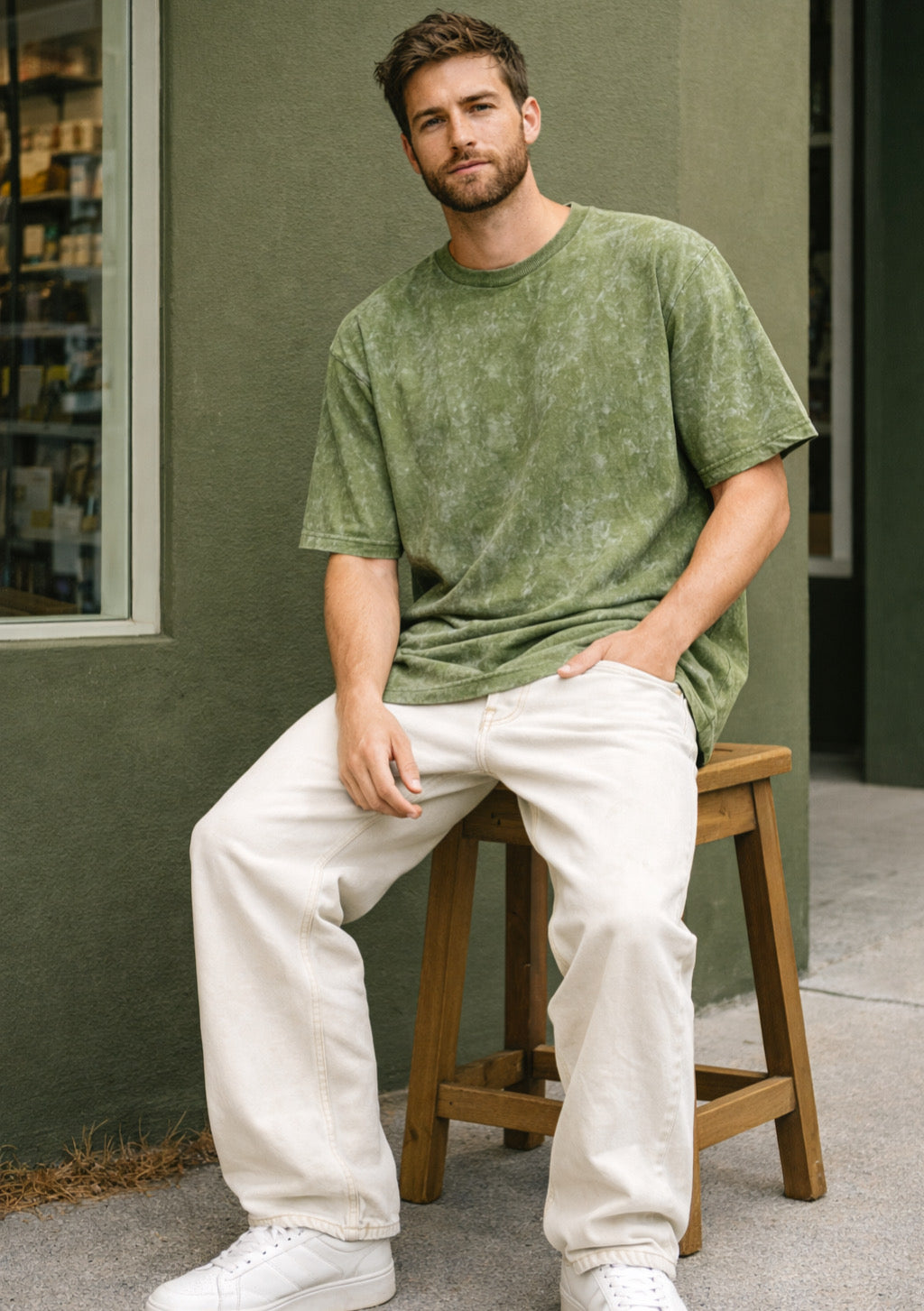 Montx men's army green acid wash French Terry cotton oversized T-shirt hanging on a hanger.